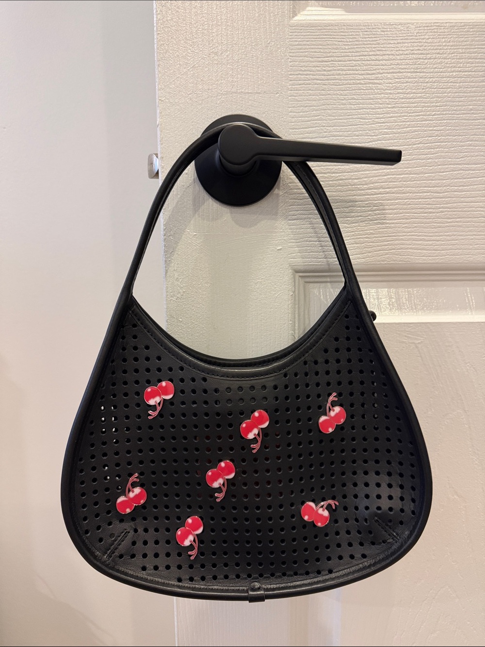 Black Perforated Shoulder Bag with Red Cherry Accents